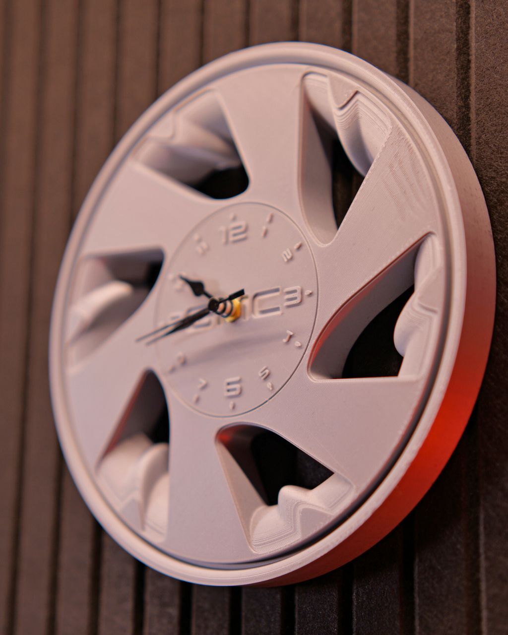 Automotive inspired Syclone wheel wall clock mounted in garage workspace